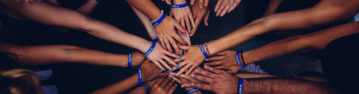 Hands reaching together for a team